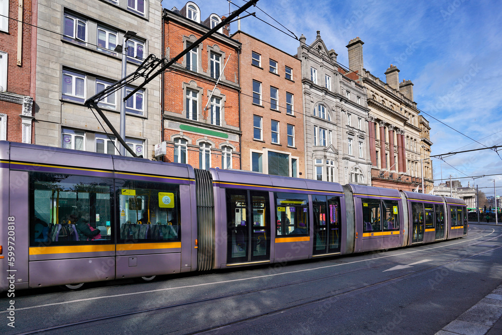 Modern Dublin tram train heading towards Parliament House on College Street