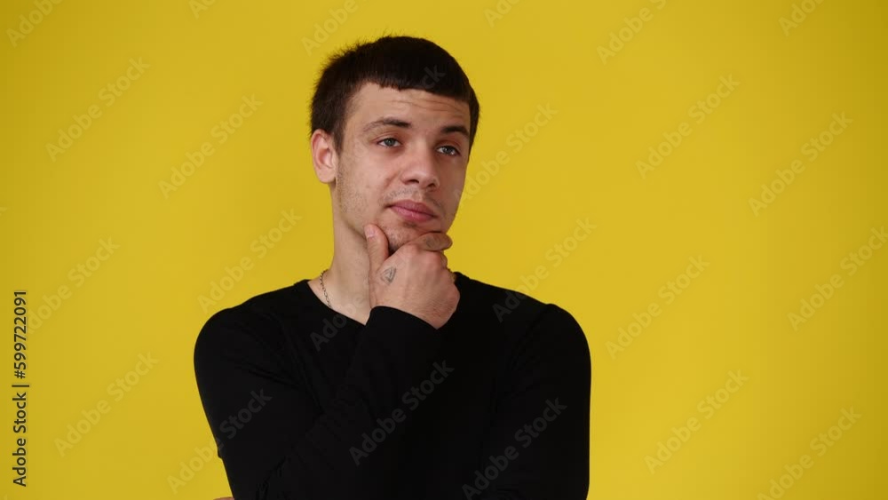 4k video of a man thinking about something over yellow background. 4k video of a man thinking about something over yellow background.