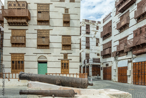 Al-Balad old town with traditional muslim houses and old cannons in the foreground, Jeddah, Saudi Arabia photo