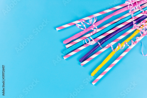 a top view colorful straws long sticky isolated on the blue background drink juice cold color