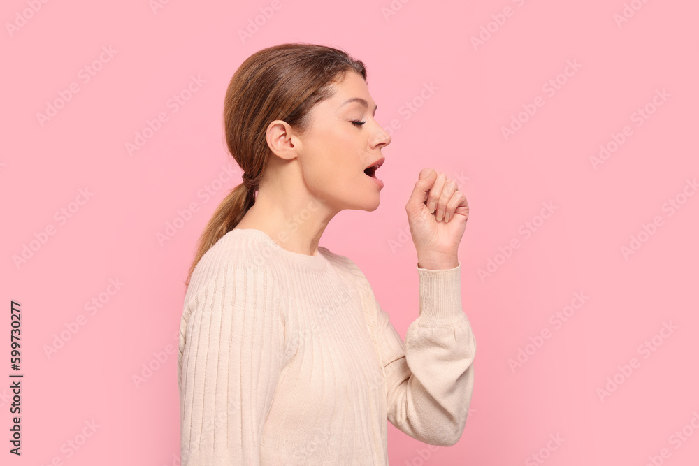Woman coughing on pink background. Sore throat Woman coughing on pink background. Sore throat