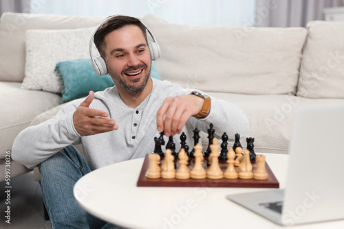 Teacher near chessboard conducting online lesson at home. Time for hobby