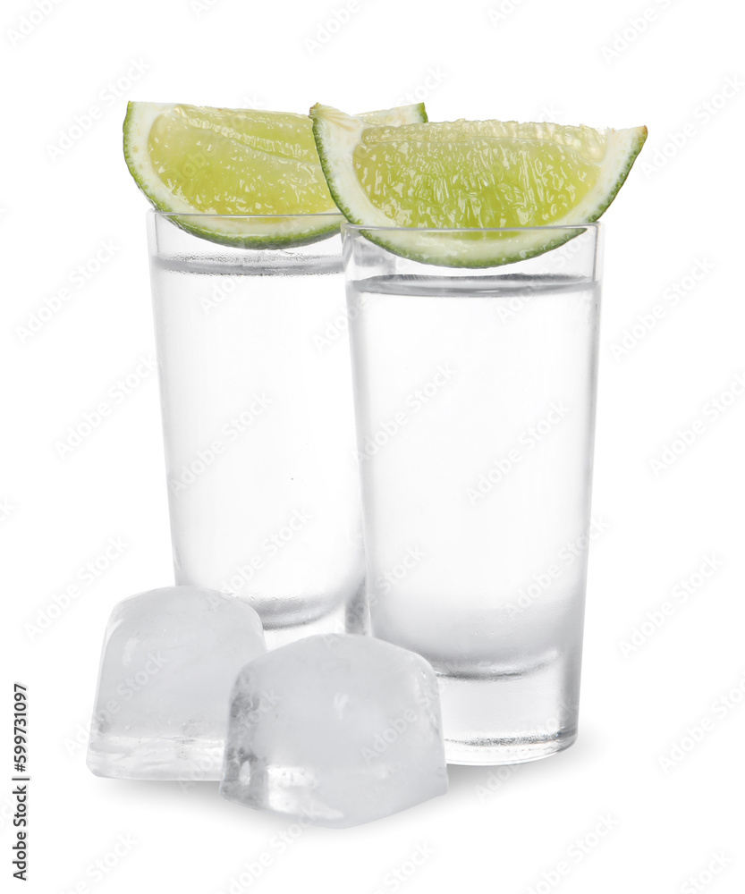 Shot glasses of vodka with lime slices and ice on white background Shot glasses of vodka with lime slices and ice on white background