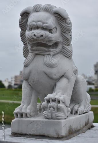 Traditional stone guardian lion outside a Chinese temple