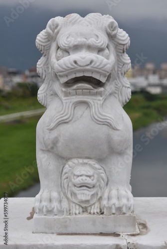 Small guardian lion on a bridge near a temple in Taiwan