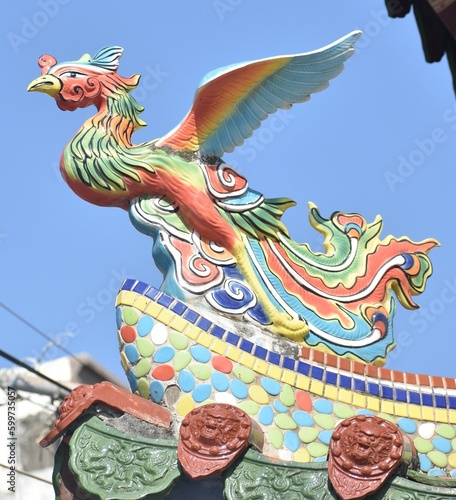 Colourful phoenix statue on the top of a Chinese temple