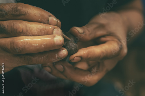 Craftsman working the clay with his hands to make figures for spectacular ornaments. photo