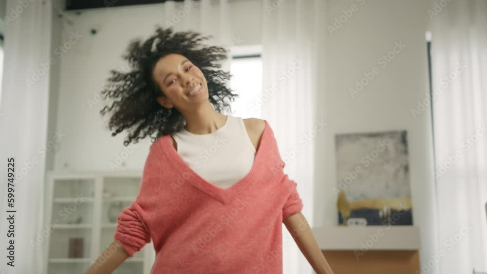 Active african american black woman in pink coral sweater dancing at modern loft apartment background. Cool talented mixed race female dancer feeling free moves rhythmically to popular music beat 4K Active african american black woman in pink coral sweater dancing at modern loft apartment background. Cool talented mixed race female dancer feeling free moves rhythmically to popular music beat 4K