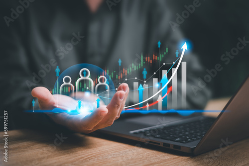 Fototapeta Naklejka Na Ścianę i Meble -  Customer relationship management and business growth concept, Businessman use a laptop and show marketing graph analyzing stock market changes with customer relationship management