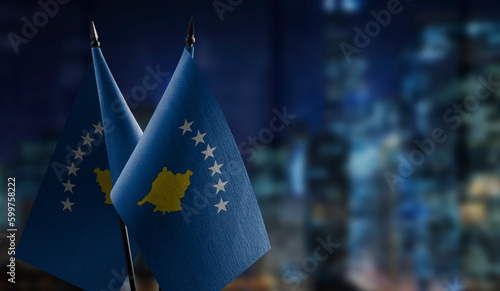 Small flags of the Kosovo on an abstract blurry background