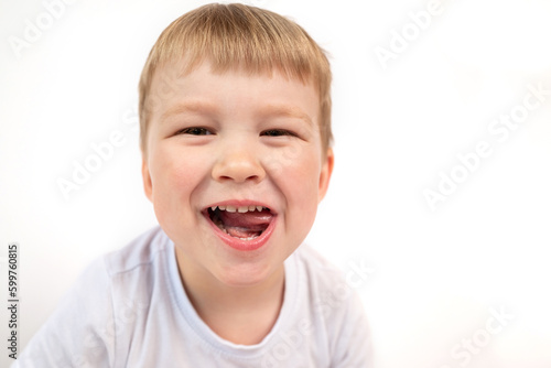 Cute child boy shows his baby white healthy teeth and open mouth close-up. The concept of oral hygiene, healthy teeth