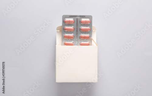 White box mockup with blister pills on gray background. Template for design photo