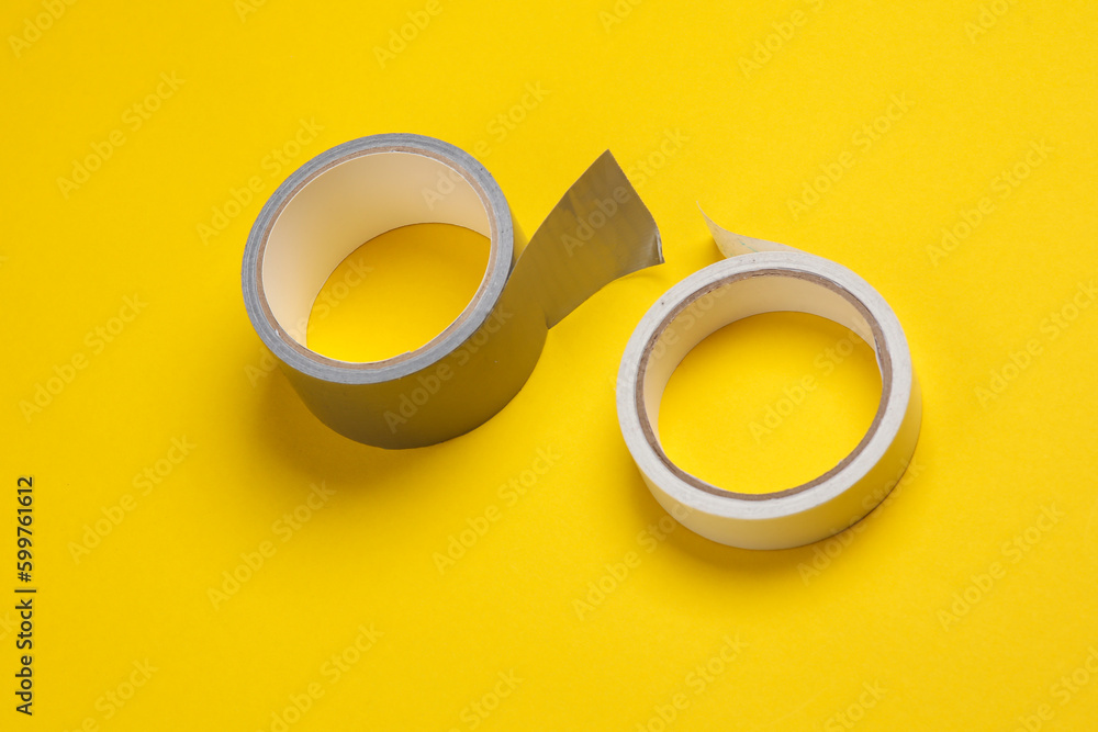 Rolls of duct tape on yellow background Rolls of duct tape on yellow background