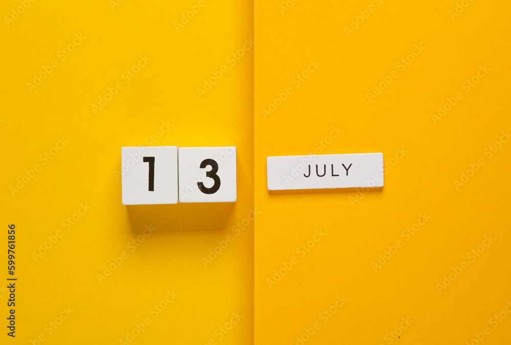 White calendar cubes with date july 13 on yellow background. Creative layout White calendar cubes with date july 13 on yellow background. Creative layout
