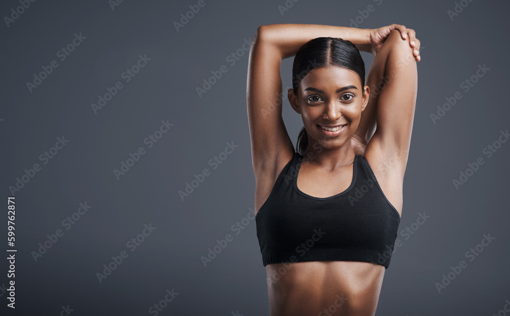 Portrait, mockup and stretching with an athlete woman in studio on a gray background for fitness or health. Exercise, workout and warm up with an attractive young female model training her body - obrazy, fototapety, plakaty 