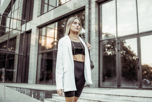 Young fashion blonde woman in trendy outfit posing in the city. Street fashion © splitov27