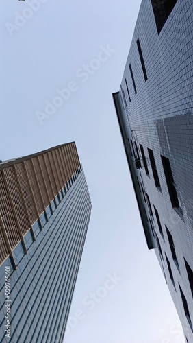 Bottom view of modern skyscrapers high buildings in Jakarta business district against afternoon. Looking up at business buildings in downtown