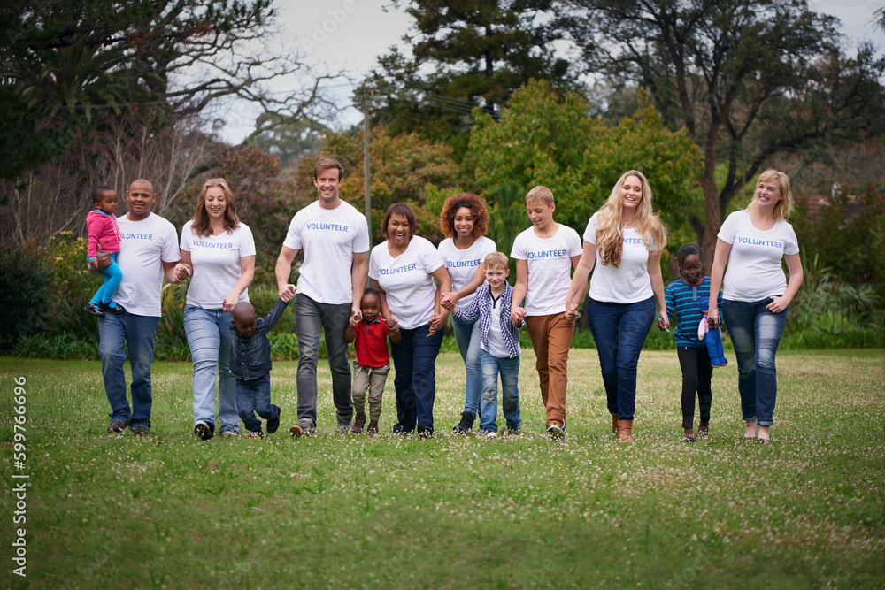 Obraz premium Charity, children and community with volunteer people in the park together for humanitarianism or activism. Nature, support or teamwork with adults and kids cleaning their environment for social work