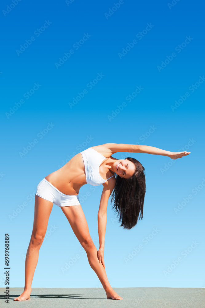 Woman, yoga and stretching arms for body, workout or exercise standing on floor against blue sky. Calm and peaceful female yogi in warm up arm or fitness stretch for healthy living on mockup space Woman, yoga and stretching arms for body, workout or exercise standing on floor against blue sky. Calm and peaceful female yogi in warm up arm or fitness stretch for healthy living on mockup space