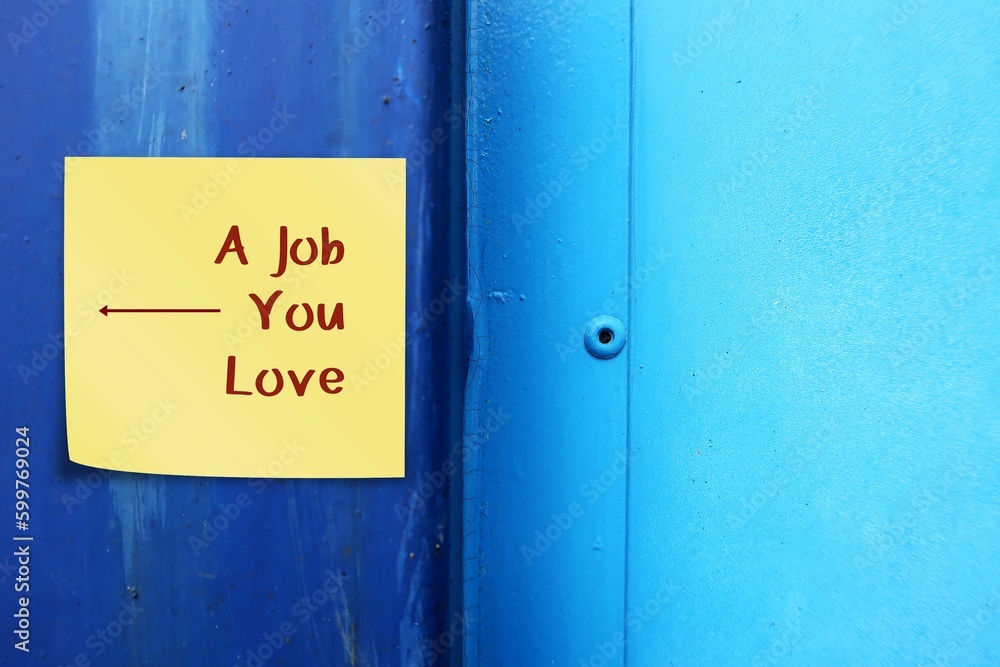 Blue copy space wall with sticky note written A JOB YOU LOVE and direction arrow , concept of finding gets to find dream job, pinpointing passions and turning them into career Blue copy space wall with sticky note written A JOB YOU LOVE and direction arrow , concept of finding gets to find dream job, pinpointing passions and turning them into career