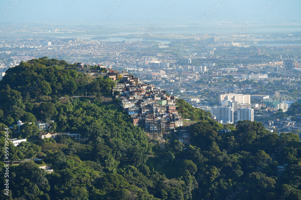 A colorful favela overlooking the Atlantic ocean in Rio de Janeiro. Beautiful sunrise view to favela on hillside in Rio de Janeiro A colorful favela overlooking the Atlantic ocean in Rio de Janeiro. Beautiful sunrise view to favela on hillside in Rio de Janeiro
