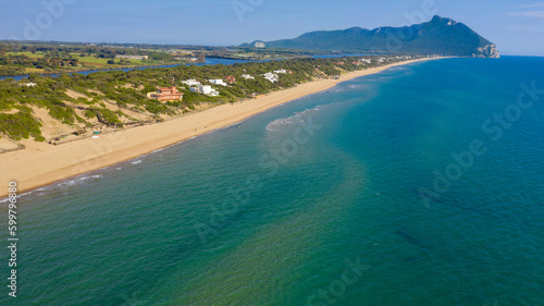 Aerial view of the seafront of Sabaudia, Italy. The beach is almost empty. In the background the Circeo promontory.