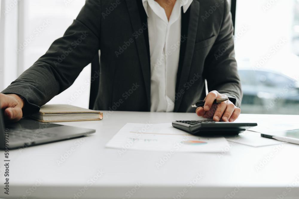 Young asian male work with financial papers at home count on calculator before paying taxes receipts online, planning budget glad to find chance for economy saving money, audit concepts. Young asian male work with financial papers at home count on calculator before paying taxes receipts online, planning budget glad to find chance for economy saving money, audit concepts.