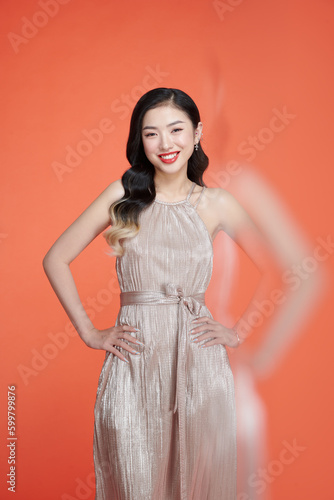 Portrait of young beautiful smiling female in trendy glamour dress