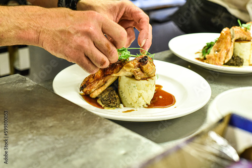 Chef working in busy kitchen preparing meals