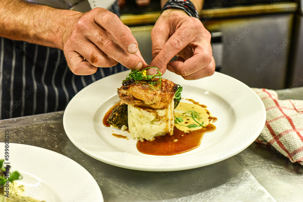 Chef working in busy kitchen preparing meals Chef working in busy kitchen preparing meals