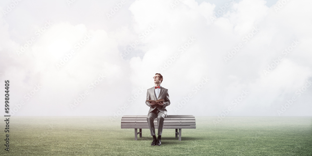 Young businessman or student studying the science in summer park Young businessman or student studying the science in summer park