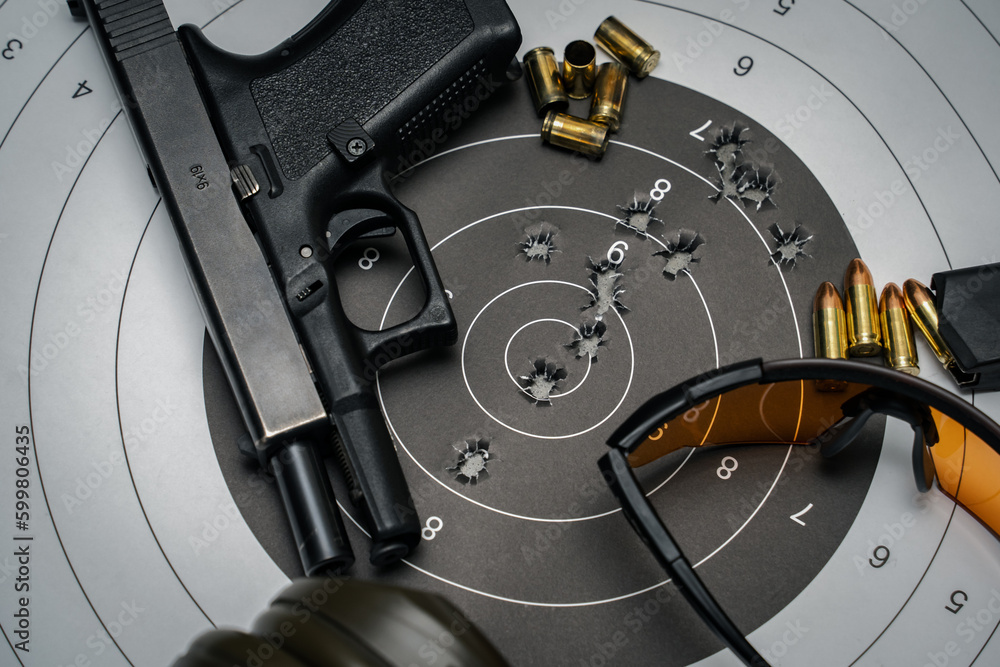 Shooting from a pistol in a shooting range. 9mm pistol target with