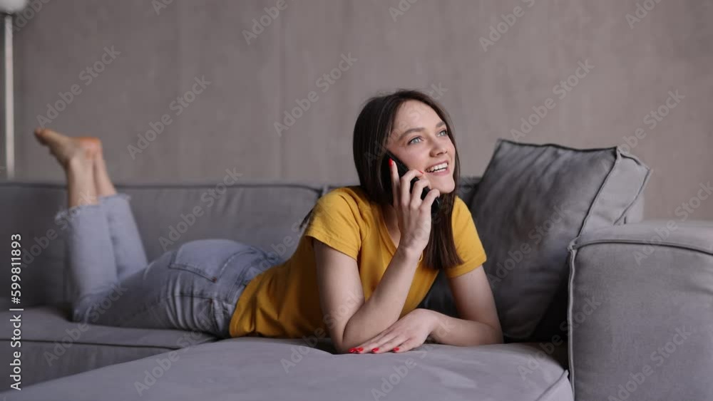 Young woman lying couch and talk phone Young woman lying couch and talk phone