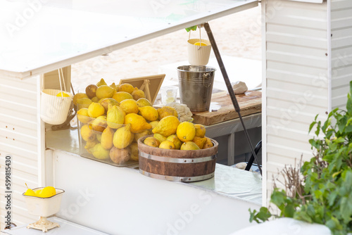 White wooden lemonade stand on the summer beach.