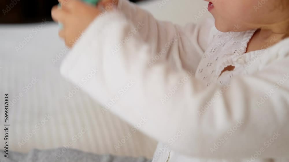 Cute baby girl playing tactile knobby balls. Young child hand plays sensory massage ball. Enhance the cognitive, physical process. Brain development. Support for Children with ADHD, autism, fidgeting. Cute baby girl playing tactile knobby balls. Young child hand plays sensory massage ball. Enhance the cognitive, physical process. Brain development. Support for Children with ADHD, autism, fidgeting.
