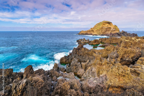 Lava rocks natural volcanic pools in Porto Moniz, Madeira island, Portugal. Dramatic seascape. Beauty of nature concept background. Panoramic view. © lesia
