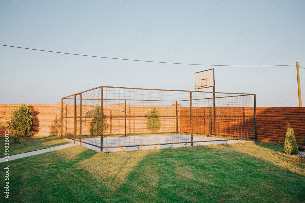 gated basketball court in backyard