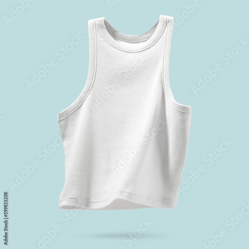 Summer Women's Clothing. Ribbed white tank top flying on light blue background. Female comfortable cotton cloth. Creative template for design Mock up. Copy space