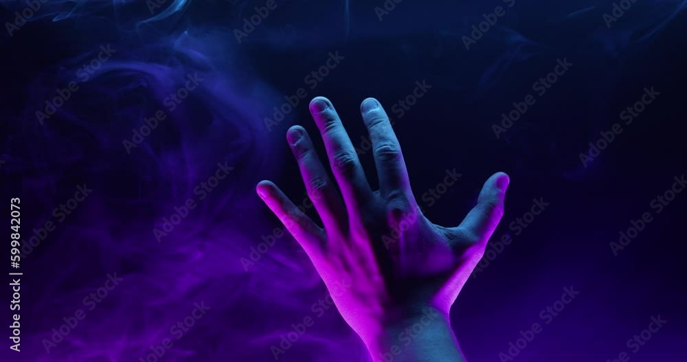 Mystical hand in smoke on a dark background. Mystical hand in smoke on a dark background.