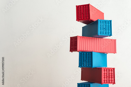 Obraz na płótnie Blue and red containers model stacked with white wall background copy space