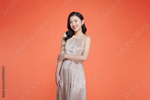 Holidays celebration concept. Happy young asian woman in fancy dress with sequins