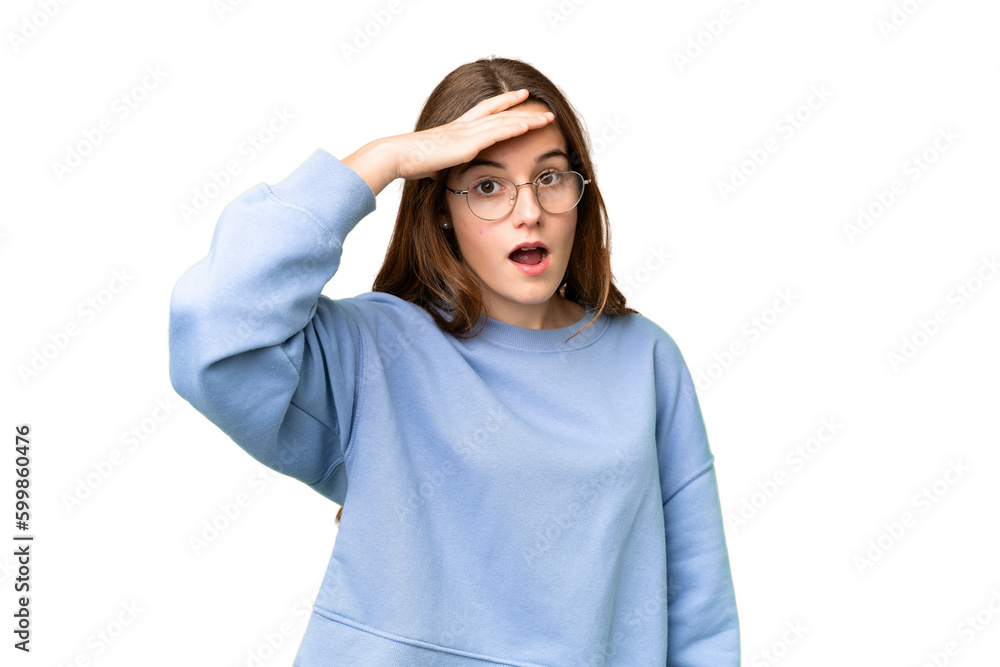 Teenager girl over isolated chroma key background doing surprise gesture while looking front Teenager girl over isolated chroma key background doing surprise gesture while looking front