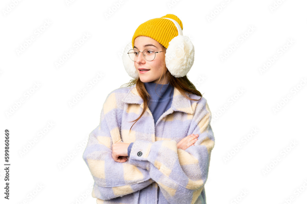 Teenager girl wearing winter muffs over isolated chroma key background happy and smiling Teenager girl wearing winter muffs over isolated chroma key background happy and smiling