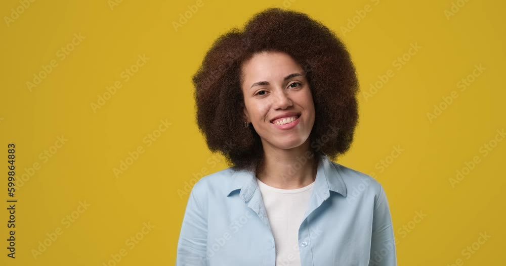 Smiling attractive african american woman standing over orange studio background Smiling attractive african american woman standing over orange studio background