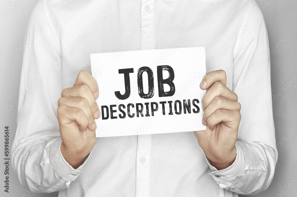 Man holding a paper card with text Job Descriptions Man holding a paper card with text Job Descriptions