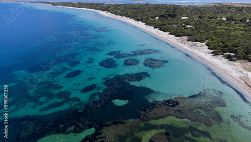 aerial view of the crystal clear sea waters of the beach of is solinas in southern sardinia 