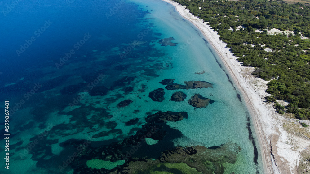 aerial view of the crystal clear sea waters of the beach of is solinas in southern sardinia
