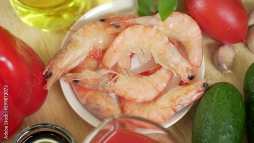 Fresh boiled shrimp in a bowl among other ingredients for the warm shrimp salad photo