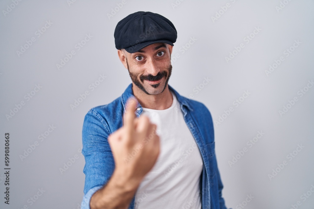 Hispanic man with beard standing over isolated background beckoning come here gesture with hand inviting welcoming happy and smiling Hispanic man with beard standing over isolated background beckoning come here gesture with hand inviting welcoming happy and smiling