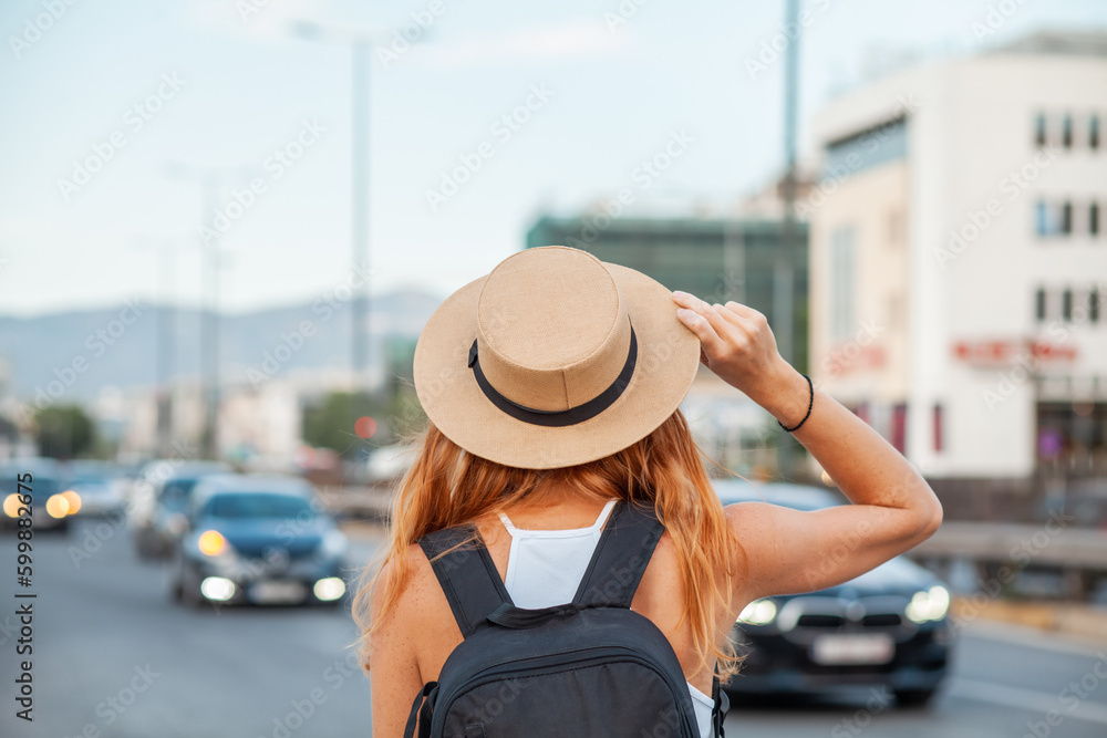 Fototapeta premium Happy beautiful young woman smiling in the city street - Delightful girl enjoying sunny day out - Healthy lifestyle concept with female laughing outside. 